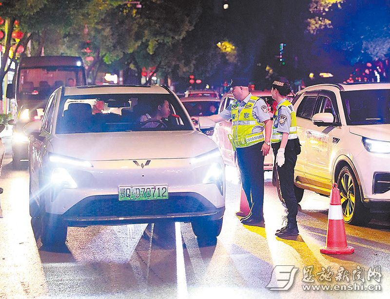 7月11日晚，施州大道和润城路段，交警对驾驶员进行酒精检测。 （全媒体记者 刘 磊 摄）